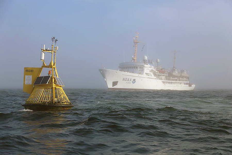 A buoy and NOAA ship on the ocean