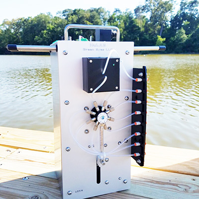 Photo of water monitoring device sitting on a lakeside pier