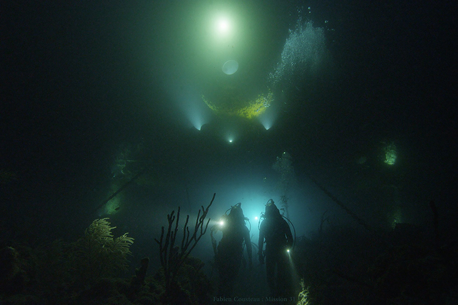 Deep-sea divers around an underwater laboratory
