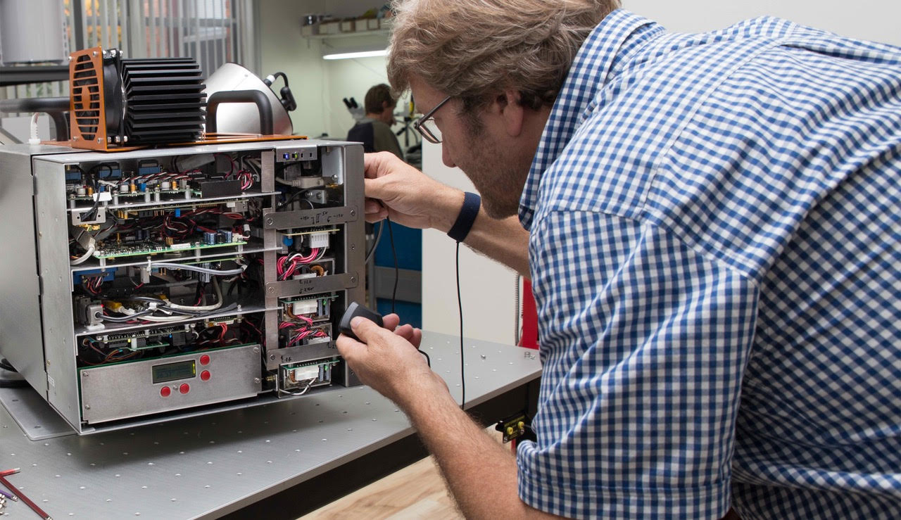 Man adjusts scientific equipment